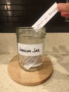 Image of hand depositing paper that says best-in-breed into the open Jargon Jar