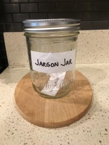 Image of sealed Jargon Jar with the hand-written 'Leverage' paper inside it
